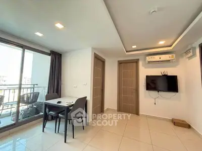 Modern living room with balcony access and sleek furniture in a contemporary apartment.