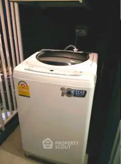 Compact washing machine in a modern apartment balcony corner