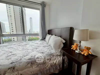 Cozy bedroom with city view, featuring plush bedding and elegant decor, perfect for urban living.
