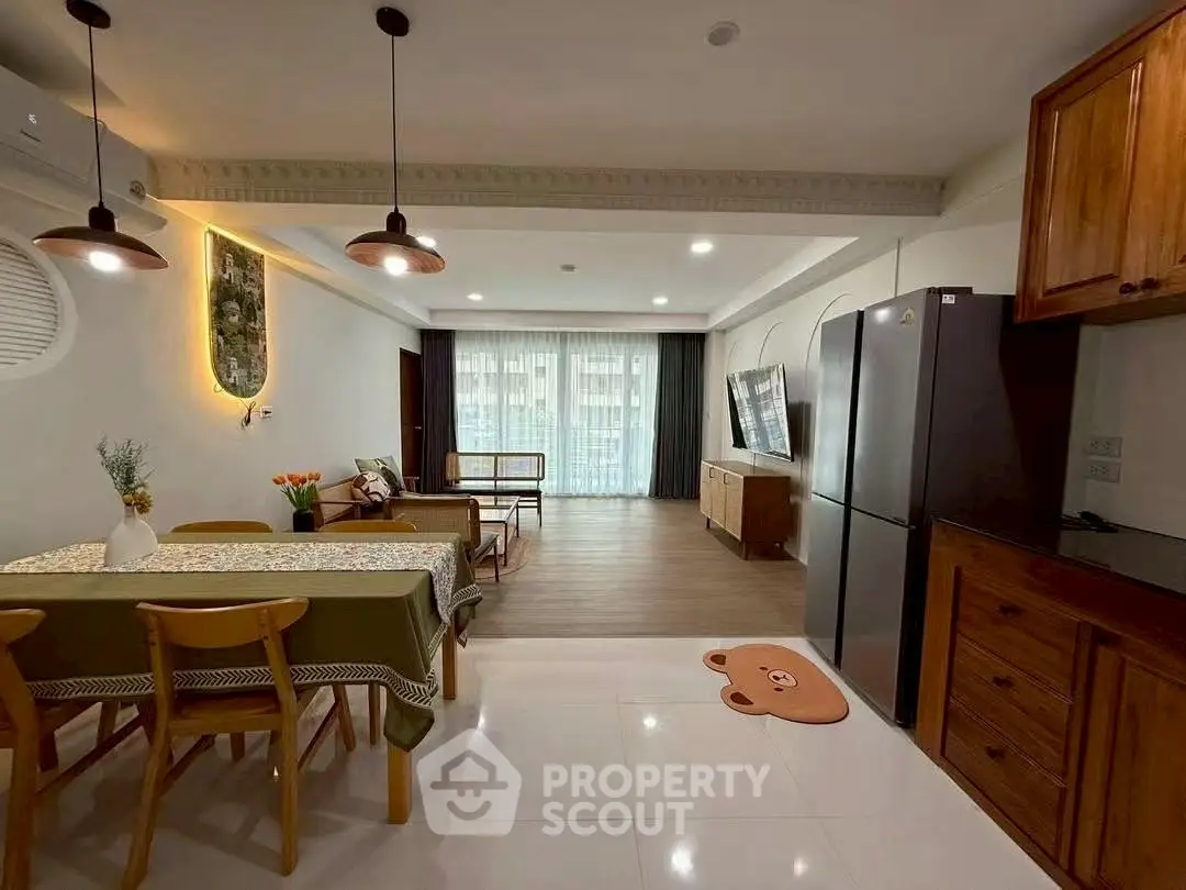 Spacious open-plan living room with modern kitchen and stylish decor.