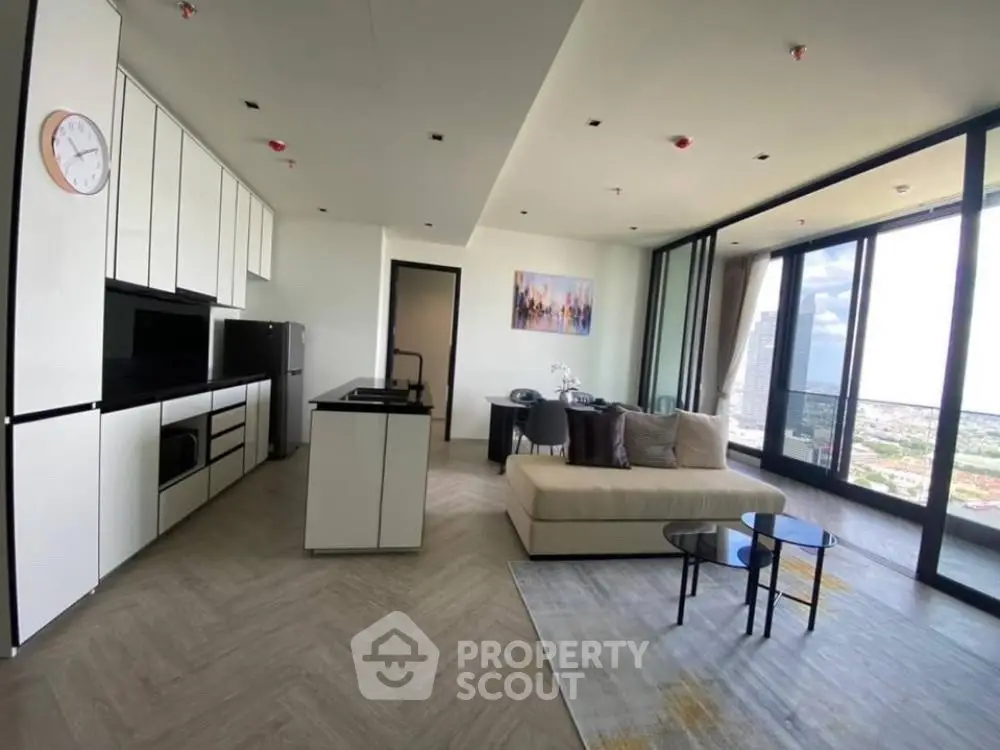 Modern open-layout kitchen and living room with panoramic city view
