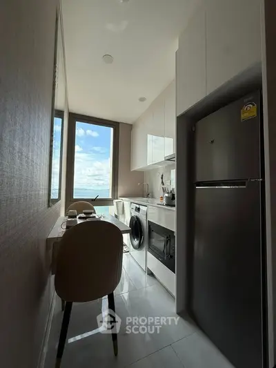 Modern kitchen with sleek appliances and stunning view, perfect for urban living.