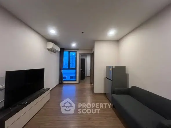 Modern living room with sleek furniture and city view window