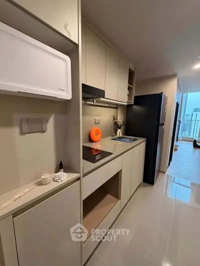 Modern kitchen with sleek cabinetry and appliances in a stylish apartment