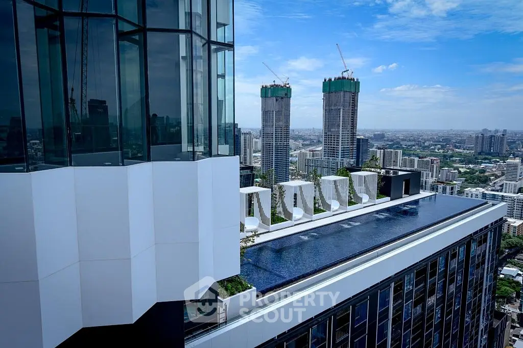 Stunning rooftop pool with panoramic city views in modern high-rise building.