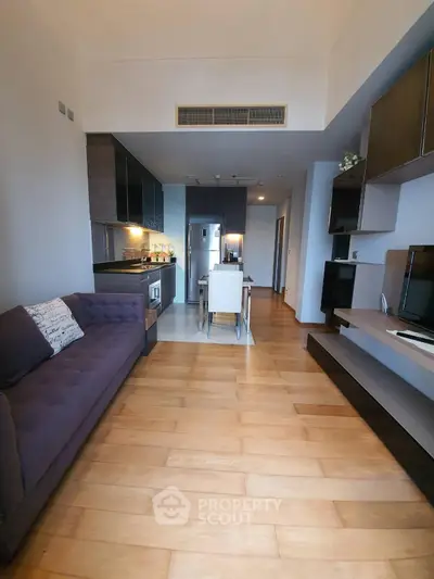 Modern living room with open kitchen layout and stylish decor