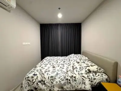 Cozy bedroom with modern decor and floral bedding in a stylish apartment.