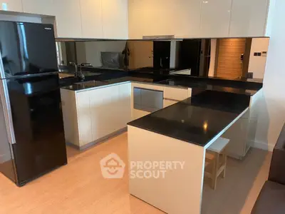 Modern kitchen with sleek black countertops and high-gloss cabinets