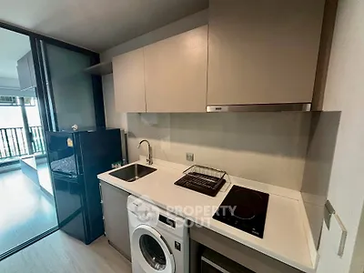 Modern kitchen with sleek appliances and open layout in stylish apartment