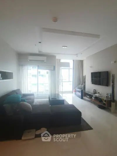 Spacious modern living room with large windows and stylish decor