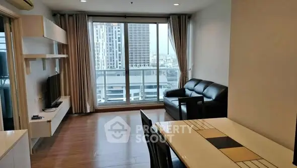Modern living room with city view, sleek furniture, and natural light.