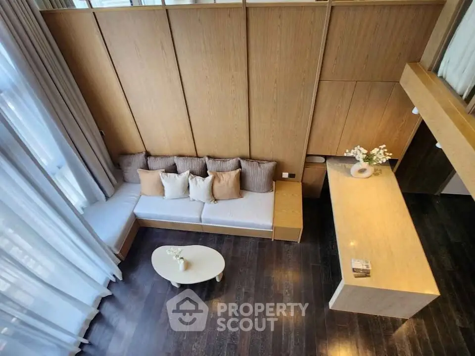 Modern living room with elegant wooden paneling and cozy seating area