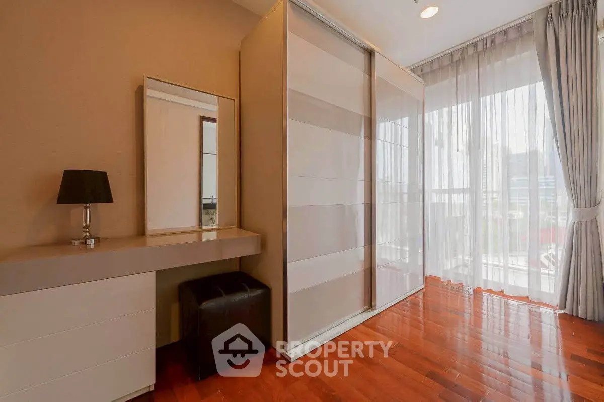 Spacious bedroom with elegant wardrobe and natural light