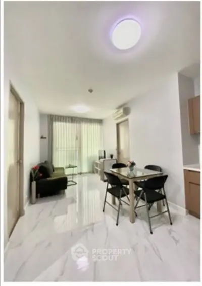 Modern living room with dining area and sleek marble flooring in a stylish apartment.
