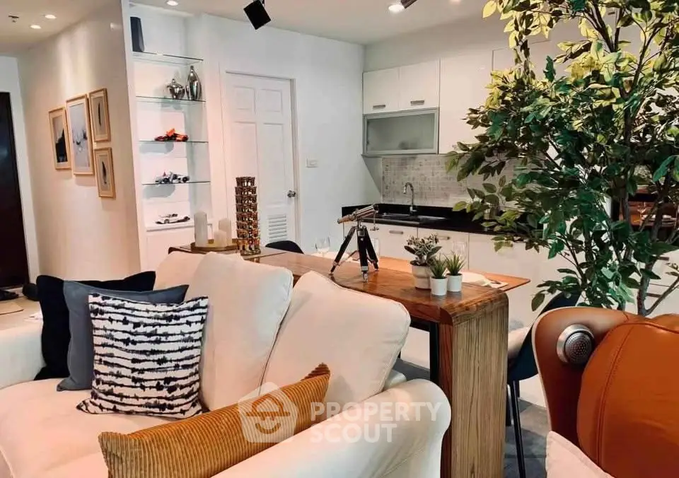 Stylish open-plan living room with modern kitchen and cozy seating area, perfect for entertaining.