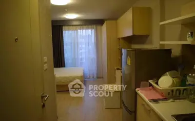 Cozy studio apartment with modern kitchen and bright bedroom area, perfect for urban living.