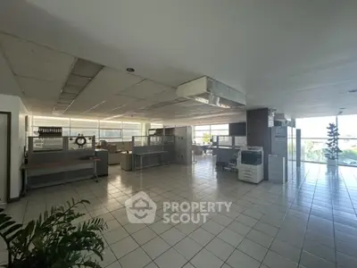 Spacious open-plan office with abundant natural light and modern furnishings