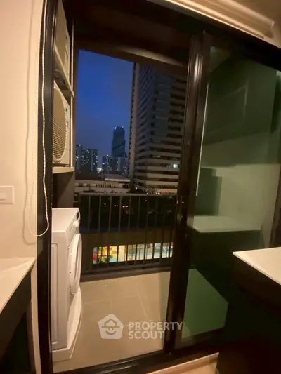 Modern apartment balcony with city view and laundry area