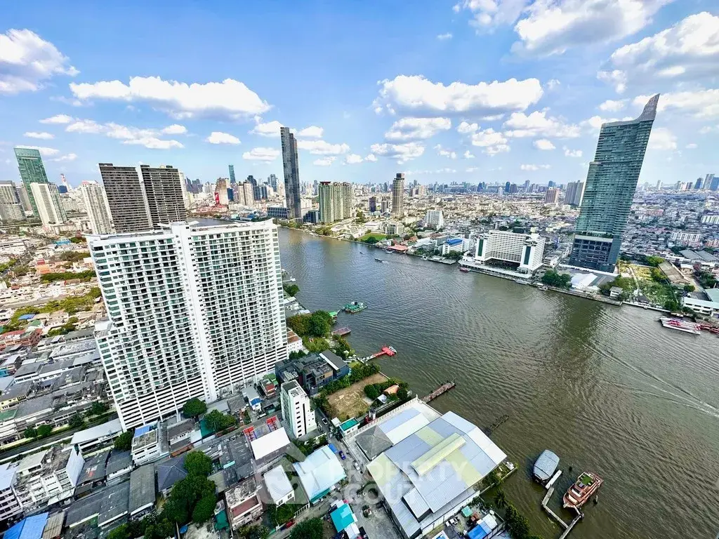 Stunning cityscape view from high-rise building overlooking river and skyline.