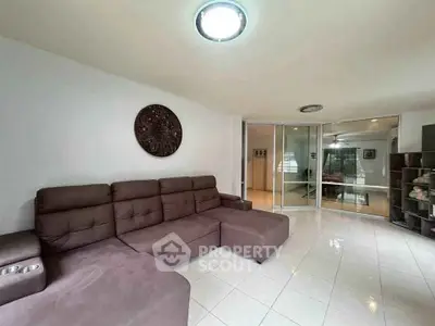 Spacious living room with modern sectional sofa and sliding glass doors