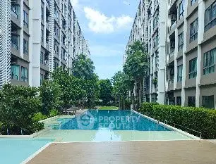 Luxurious apartment complex with stunning pool and lush greenery