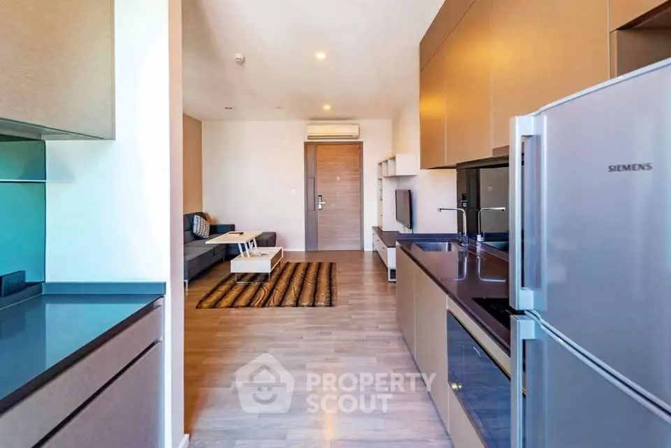 Modern open-layout kitchen and living room with sleek appliances and stylish decor