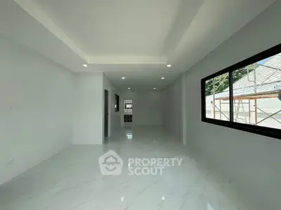 Spacious modern living room with large windows and elegant marble flooring