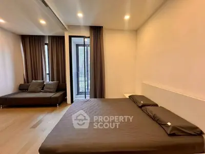 Spacious modern bedroom with large windows and elegant decor