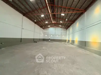 Spacious industrial warehouse with high ceilings and ample storage space.