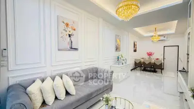 Luxurious living room with elegant chandelier and modern dining area