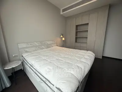 Spacious modern bedroom with stylish built-in wardrobe and cozy lighting