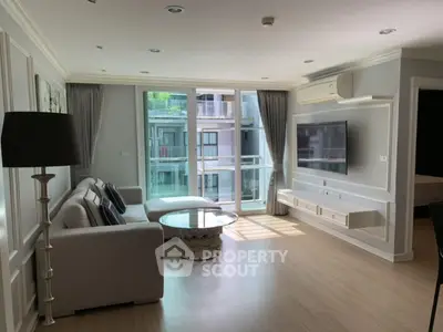 Spacious modern living room with large windows and elegant decor