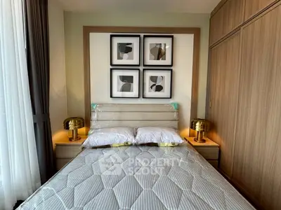 Modern bedroom with stylish decor and cozy ambiance, featuring elegant lighting and framed artwork.