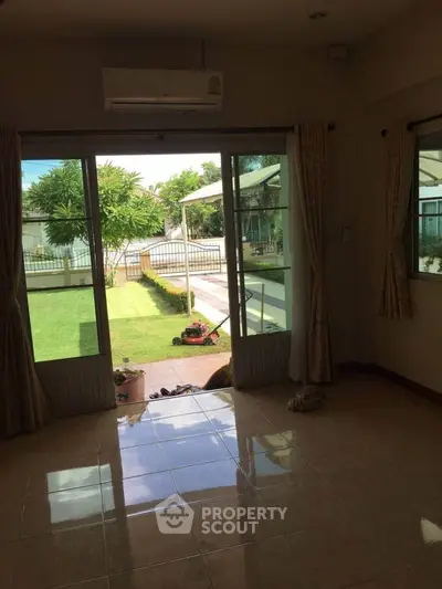 Spacious living room with garden view and sliding glass doors