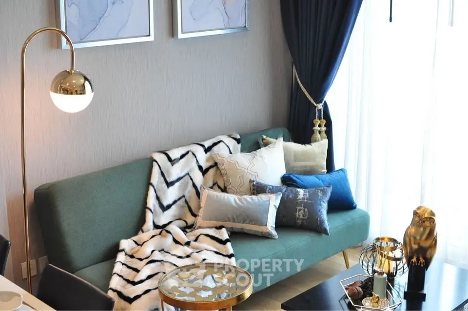 Stylish living room with modern decor, elegant sofa, and chic lighting.