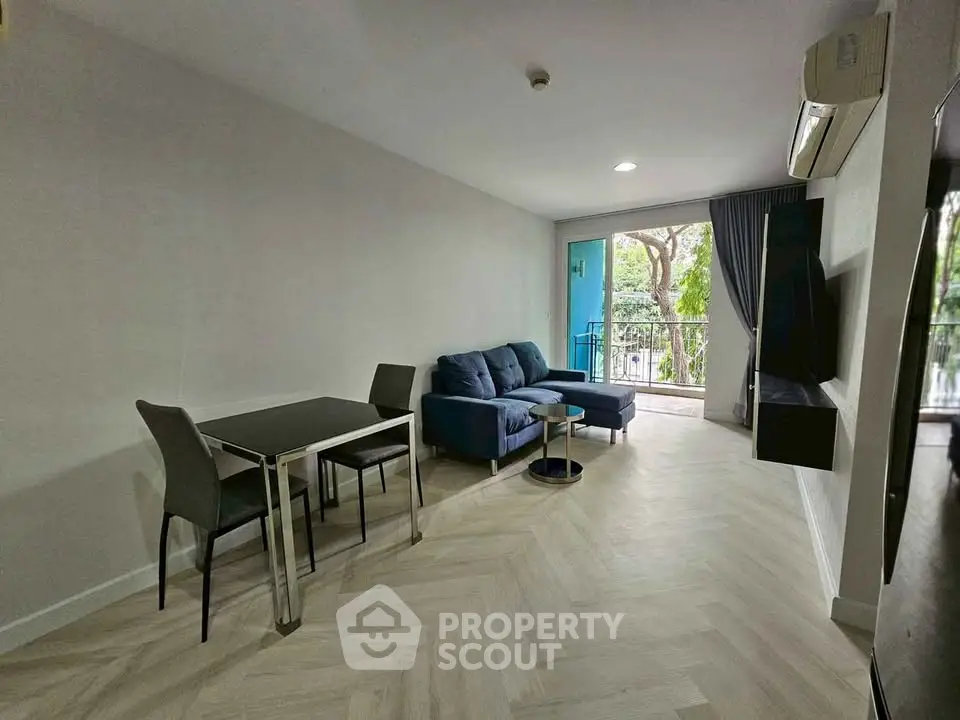 Modern living room with balcony access and stylish furniture in a bright apartment.