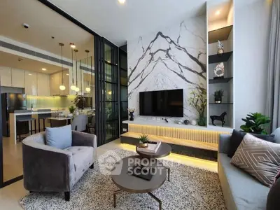 Luxurious modern living room with marble accent wall and open kitchen layout