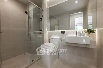 Luxurious modern bathroom with glass shower and elegant fixtures