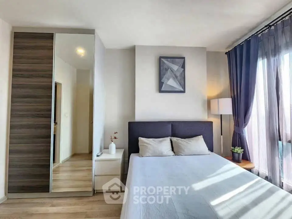 Modern bedroom with stylish decor and ample natural light
