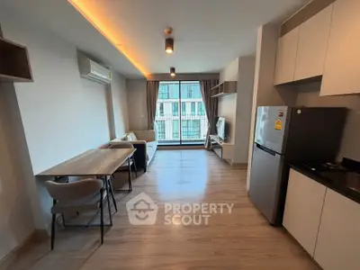 Modern open-plan living room with kitchen and large window view