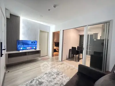 Modern living room with sleek TV setup and cozy dining area