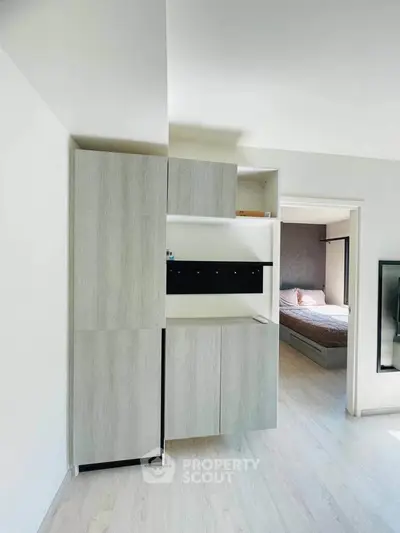 Modern minimalist interior with sleek storage and glimpse of cozy bedroom