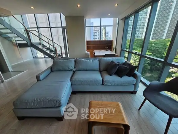 Spacious modern living room with large windows and city view