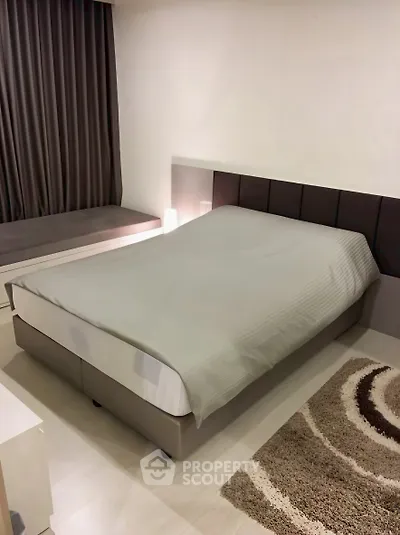 Modern bedroom with cozy bed and stylish decor in a contemporary apartment.