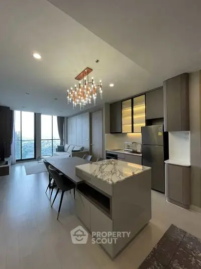 Luxurious open-plan kitchen and living room with modern decor and city view.