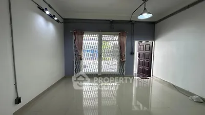 Spacious empty room with large windows and tiled flooring, ideal for customization.