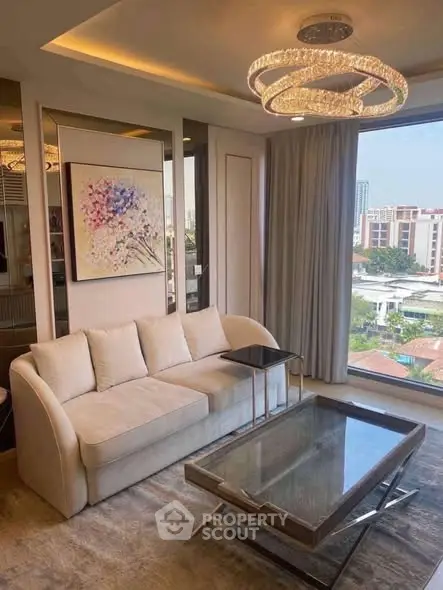 Luxurious living room with elegant chandelier and city view.