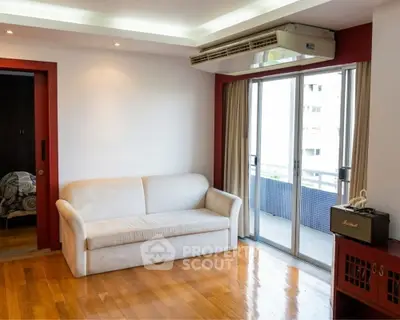 Spacious living room with balcony access and modern air conditioning unit.