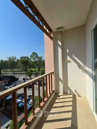 Spacious balcony with scenic view and ample sunlight, perfect for relaxation.
