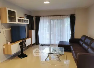 Modern living room with sleek furniture and large window for natural light